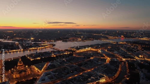 Aerial view of Isaac Cathedral, Saint Petersburg with glowing cityscape, sunset