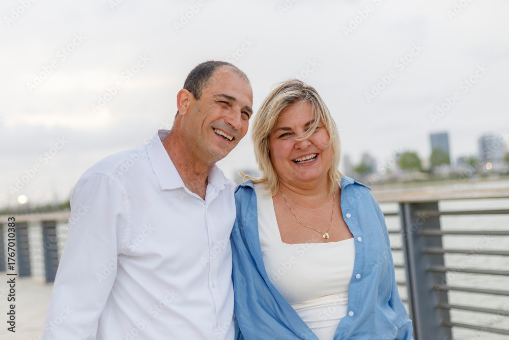 Obraz premium A woman and a man, a mature couple, are happy together. Active recreation in the park outdoors.