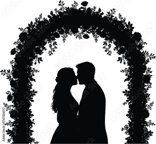 Romantic silhouette of a newlywed couple sharing a tender kiss under a floral wedding arch