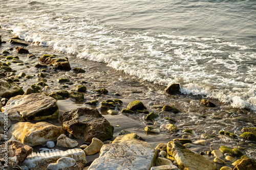 rocky coast in the light of the setting sun