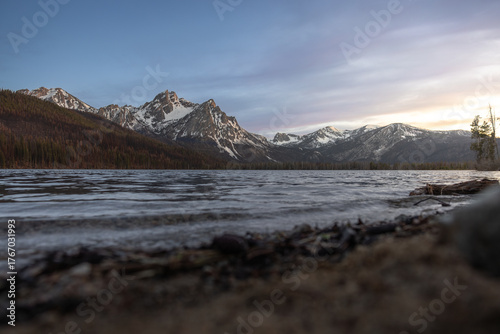 stanley lake during sunset from the beach with snow covered mountains in the sawtooth national forest in central idaho 