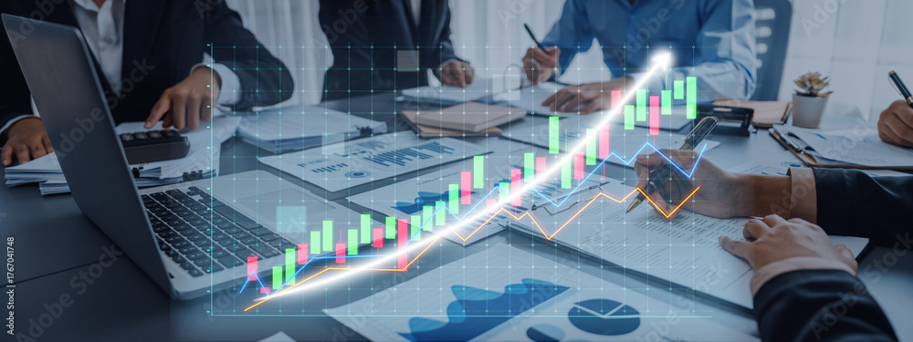 Obraz premium Professionals engage in a business meeting, analyzing charts and graphs that reflect financial growth. The modern workspace fosters collaboration and strategic discussions. Axiom