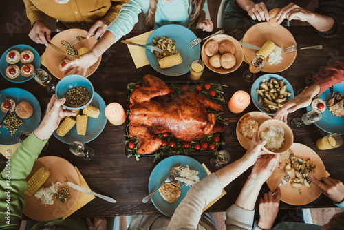 Thanksgiving table of family and friends big gathering of generations shares turkey corn and stories around a festive autumn meal