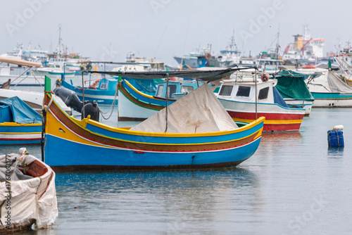 Wallpaper Mural Colorful fishing boats are docked in a harbor on an overcast day, with many other vessels visible in the background. Torontodigital.ca