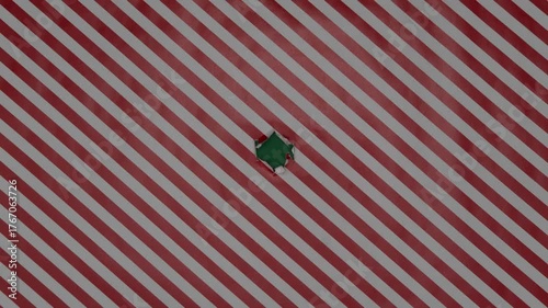 Christmas wrapping paper tears from the center on a green background. Stop motion. Layout for discounts, text, etc