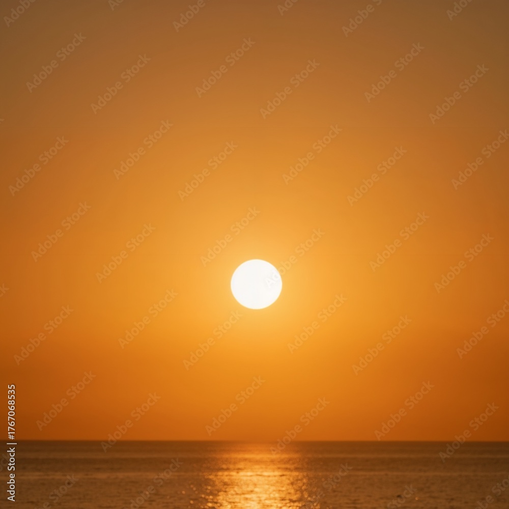 Fototapeta premium Majestic sunset over calm ocean waters with warm orange hues