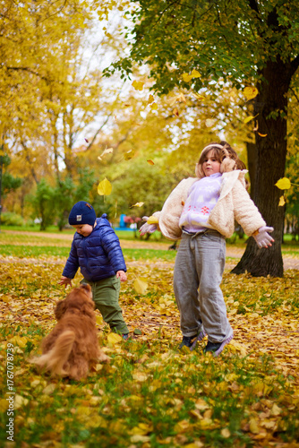 Kids having fun in the park during autumn