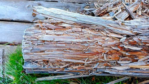 Wooden logs in the yard of a country house in winter.
