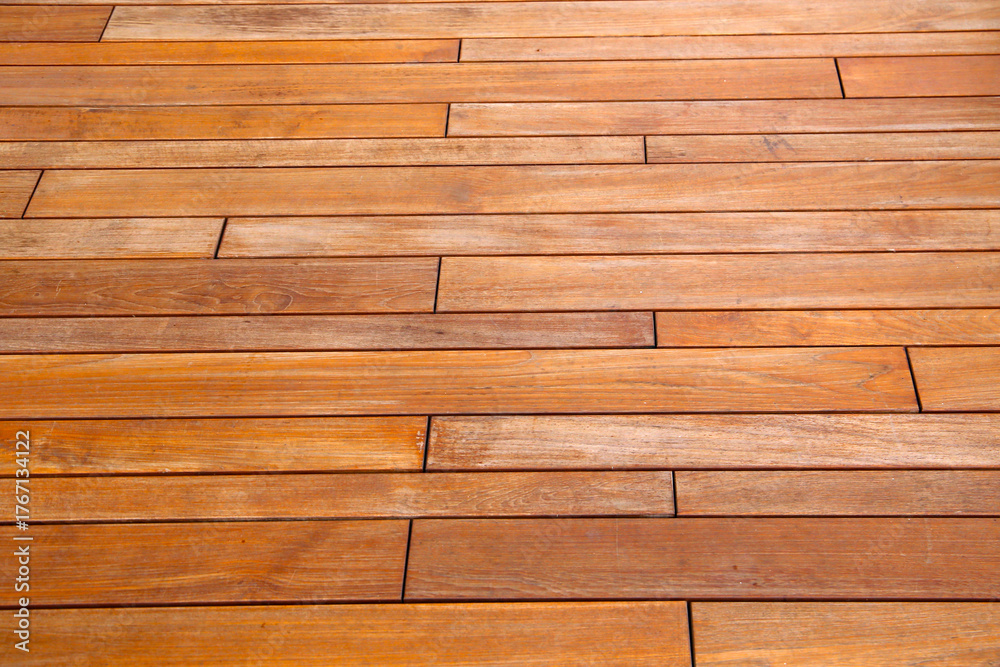 Fototapeta premium Outdoor ooden walkway surface with natural grain and warm brown tones.