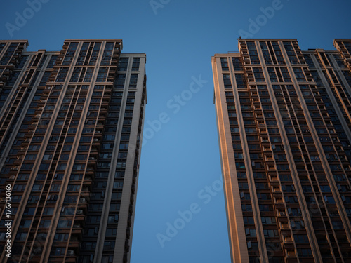 Fototapeta Towering high-rise buildings dominating the urban skyline against a clear blue s