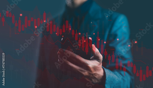 Businessman using smartphone with red falling stock market graph and candlestick chart symbolizing financial crisis, investment loss, trading risk, and economic downturn concept in finance background.