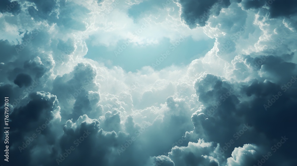Fototapeta premium A dramatic sky with dark storm clouds surrounding a bright light.