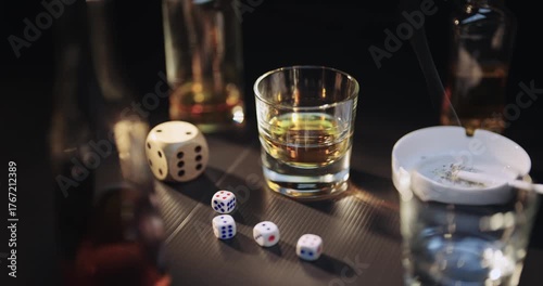 Gambling cinematic concept scene. Casino dice and glass of whiskey, cognak on dark background with smoke