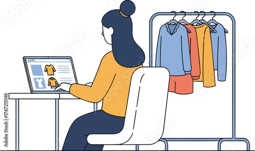 Woman enjoys online shopping for stylish apparel on her laptop with her clothing rack nearby