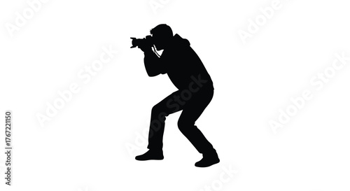 Silhouette of a photographer in action capturing a moment with a professional camera against a white background