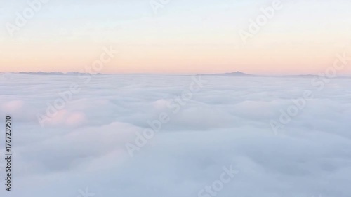 Above the Clouds: A tranquil moment above a sea of fluffy clouds, where soft light and a sense of serenity create an ethereal atmosphere.