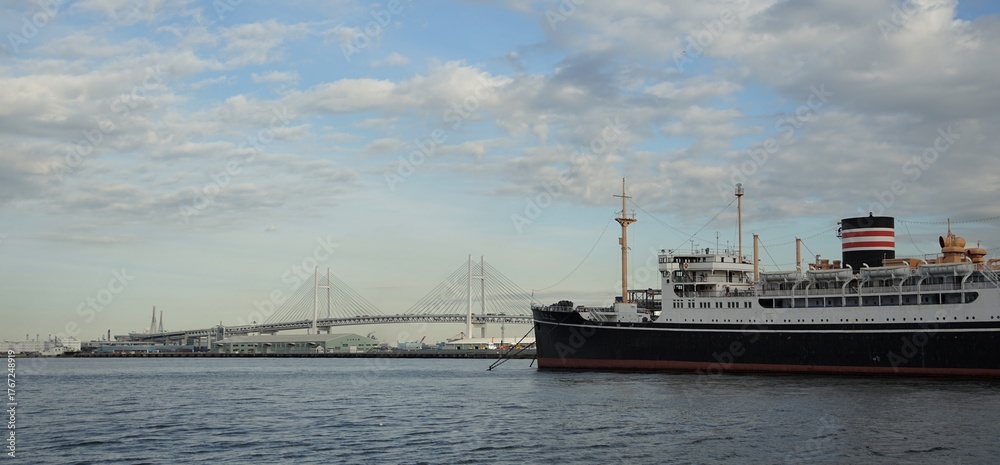 Fototapeta premium Yokohama Bay Bridge and the historic ship Hikawa Maru moored in Yokohama Port, a Japanese tourist destination