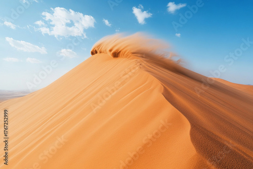 Fototapeta Naklejka Na Ścianę i Meble -  Wind blowing sand off the top of a sharp dune crest