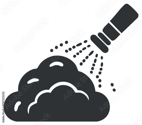 Handheld shower head spraying water onto foamy suds or lather