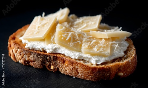  the entire spread, showcasing a single slice of slim rectangular toast with white cream cheese and on top of it