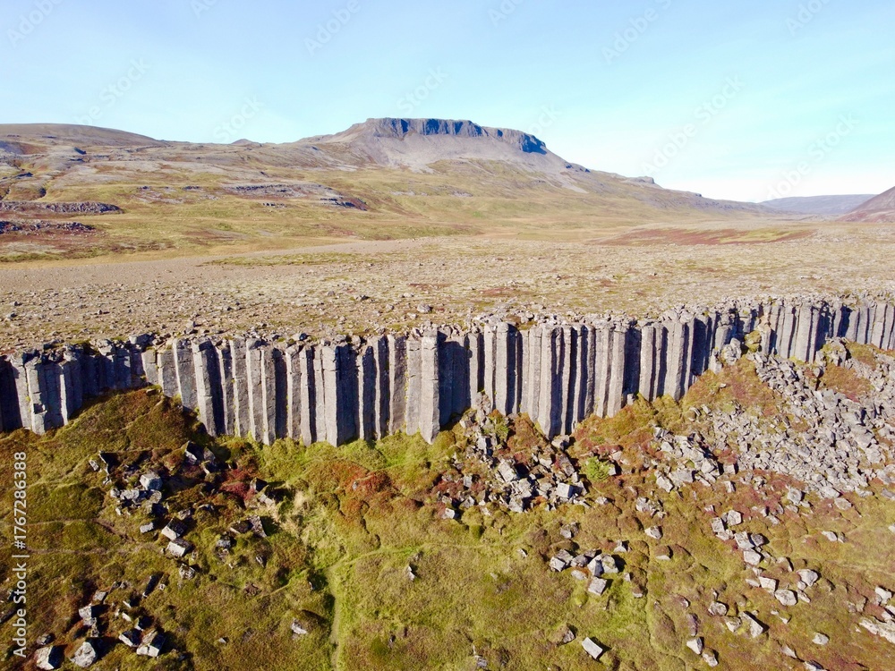 Fototapeta premium Gerðuberg Basalt Columns, Snæfellsnes Peninsula, Iceland, Geological Formation under Clear Blue Sky