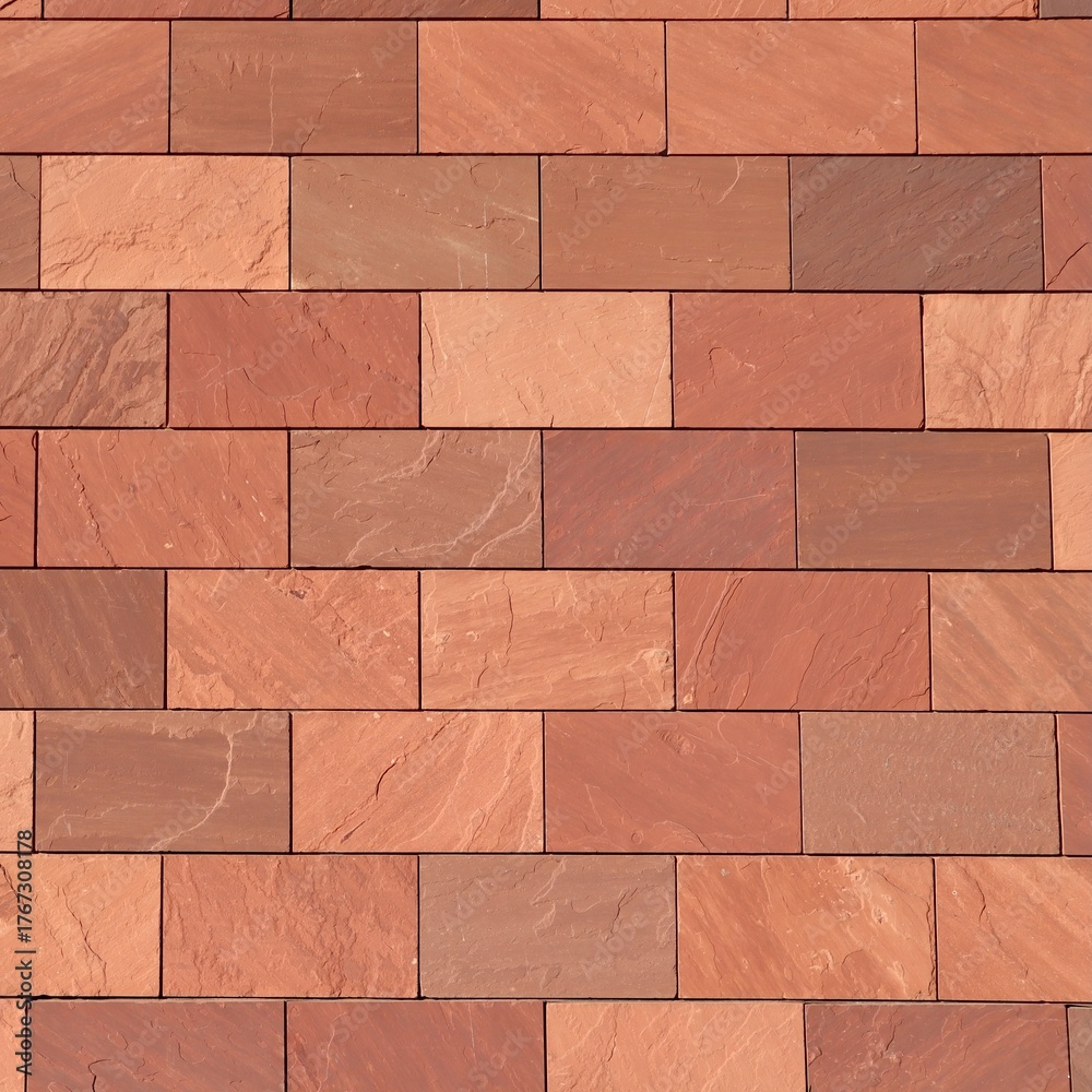 Fototapeta premium Abstract full-frame close-up of a wall of brown, terracotta-colored, and reddish rectangular bricks, showcasing their varied textures and hues in a precise, geometric pattern.