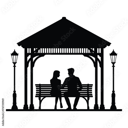 Couple silhouetted sitting on a park bench inside a gazebo
