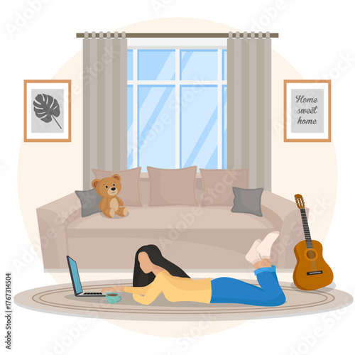 Girl working on laptop laying in living room work from home freelancer home decor cozy atmophere