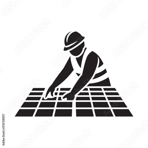 Construction worker installing solar panels on a grid