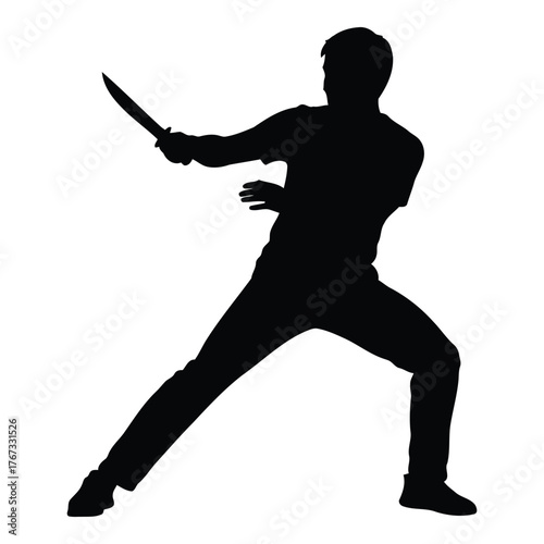 Silhouette of person wielding a knife with an aggressive stance