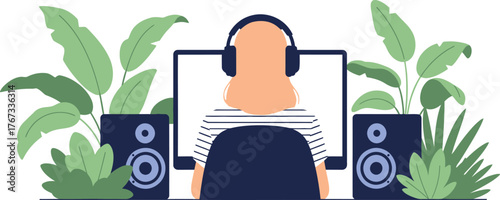 A person wearing headphones sits at a desk with a computer and speakers, surrounded by plants.