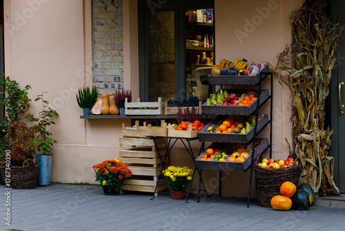market square product shop retail shelfs with fruits and vegetables raw fresh food on a counter along street European aesthetic