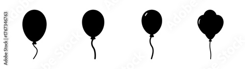 Four silhouetted balloons with strings celebration party fun festive occasion joy