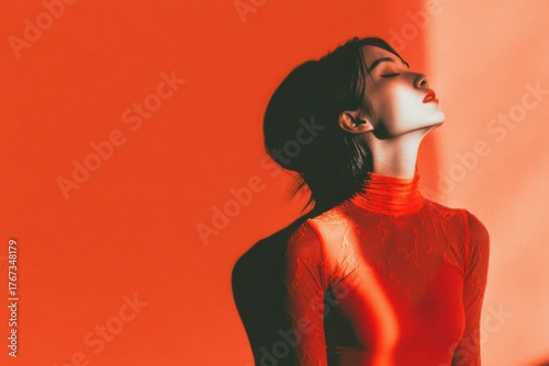 Minimalistic solarization portrait of woman in red with high contrast lighting