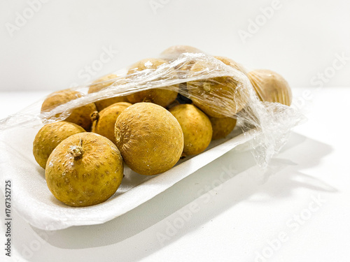 Fresh longan fruit isolated on white background. Tropical exotic fruit minimal still life. Organic longan close up. Sweet healthy fruit photography. Natural clean food concept.