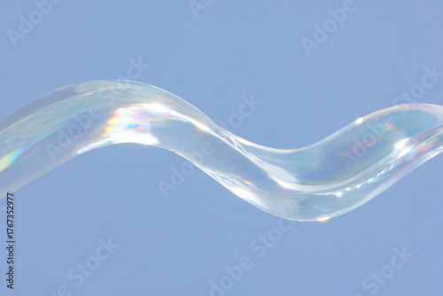 A flowing liquid wave against a light blue backdrop