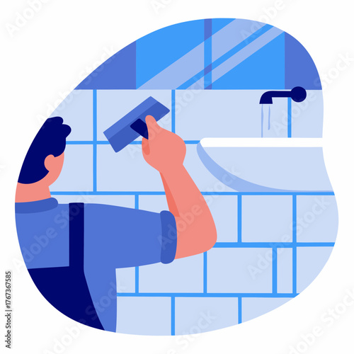 Worker applying grout to tiled wall in bathroom renovation process  