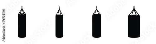 Four black punching bags hung with chains for boxing training and exercise