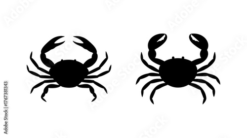 Two realistic black crab silhouettes facing different directions isolated on white