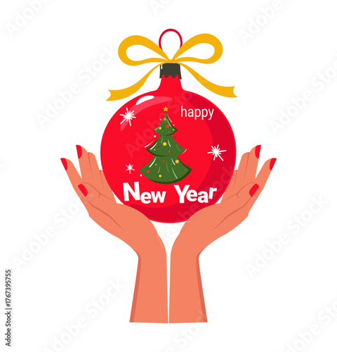 A Christmas ball is held by a woman's hand. Happy New Year.