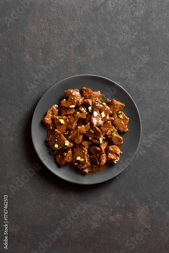 Asian style beef with soy sauce, green onion and sesame seeds