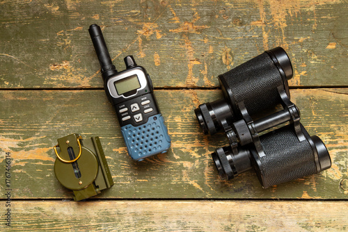 Canvas Print Radio station, black binoculars and military compass top view