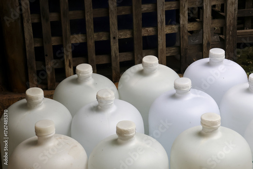 Behang Large group of white plastic carboy containers for water and liquid storage
