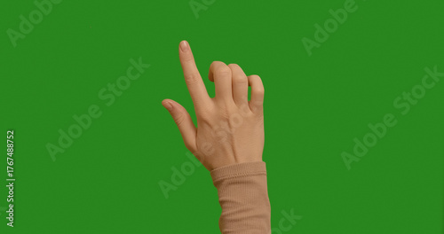 Woman swiping on chroma key green screen background. Touching Chroma Key pack. Female hand showing multitouch gestures for touch screen: Vertical, Horizontal slide, Scrolling. Interface concept.