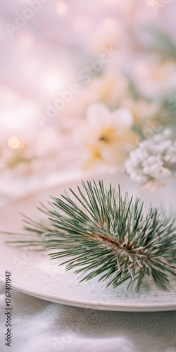Elegant holiday table setting with pine branch and white flowers for festive decor