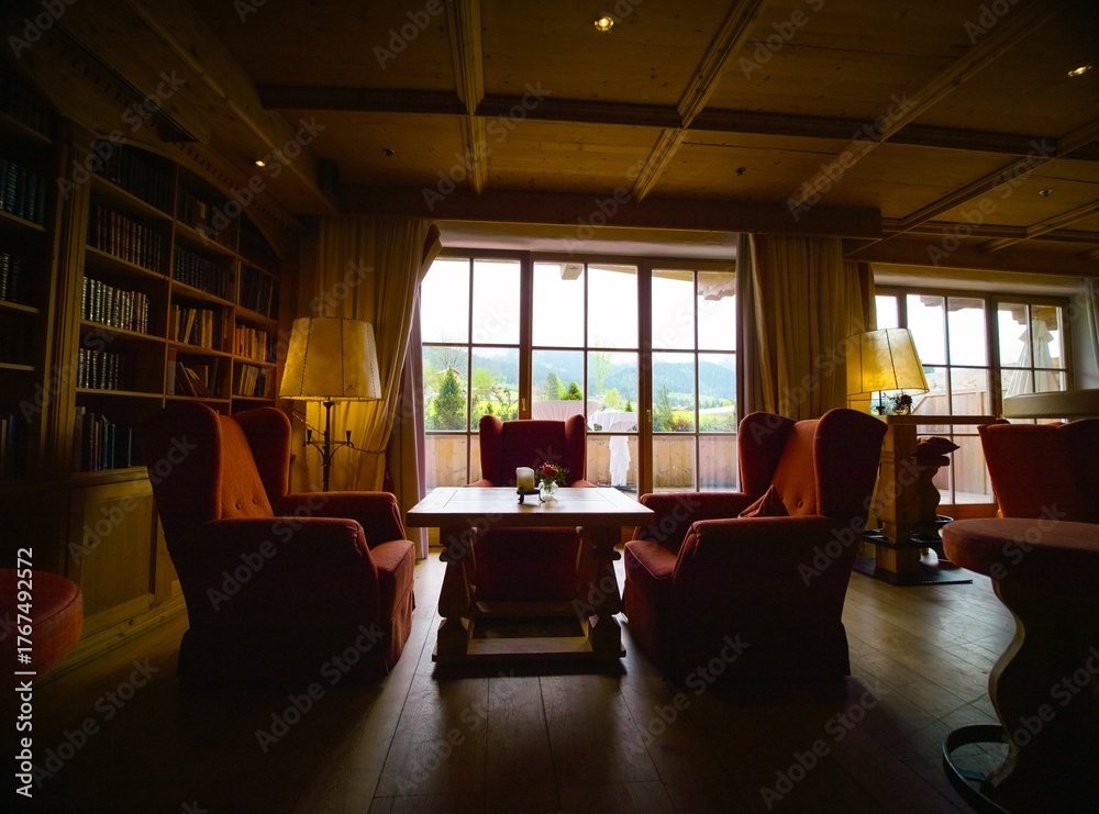 Naklejka premium Zoom in luxury armchairs and wooden table in resort. Leisure furniture and space in hotel with no people.