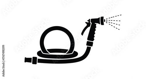 Garden hose spray nozzle connected to coiled hose spraying water element for outdoor irrigation and watering plants silhouette