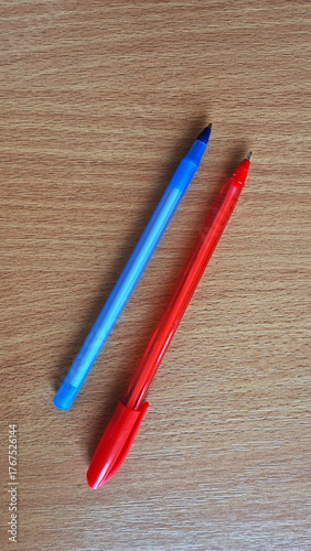 Colorful Ballpoint Pens on Wooden Surface