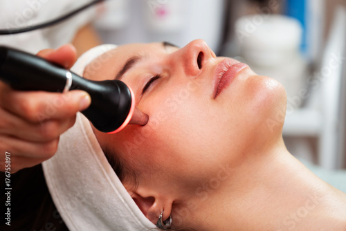 Bild auf Leinwand Woman receiving modern ultrasound anti-aging facial treatment in a clinic, esthe