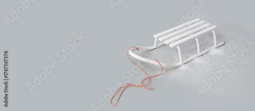 Fotografie Empty sled and snow on grey background with space for text